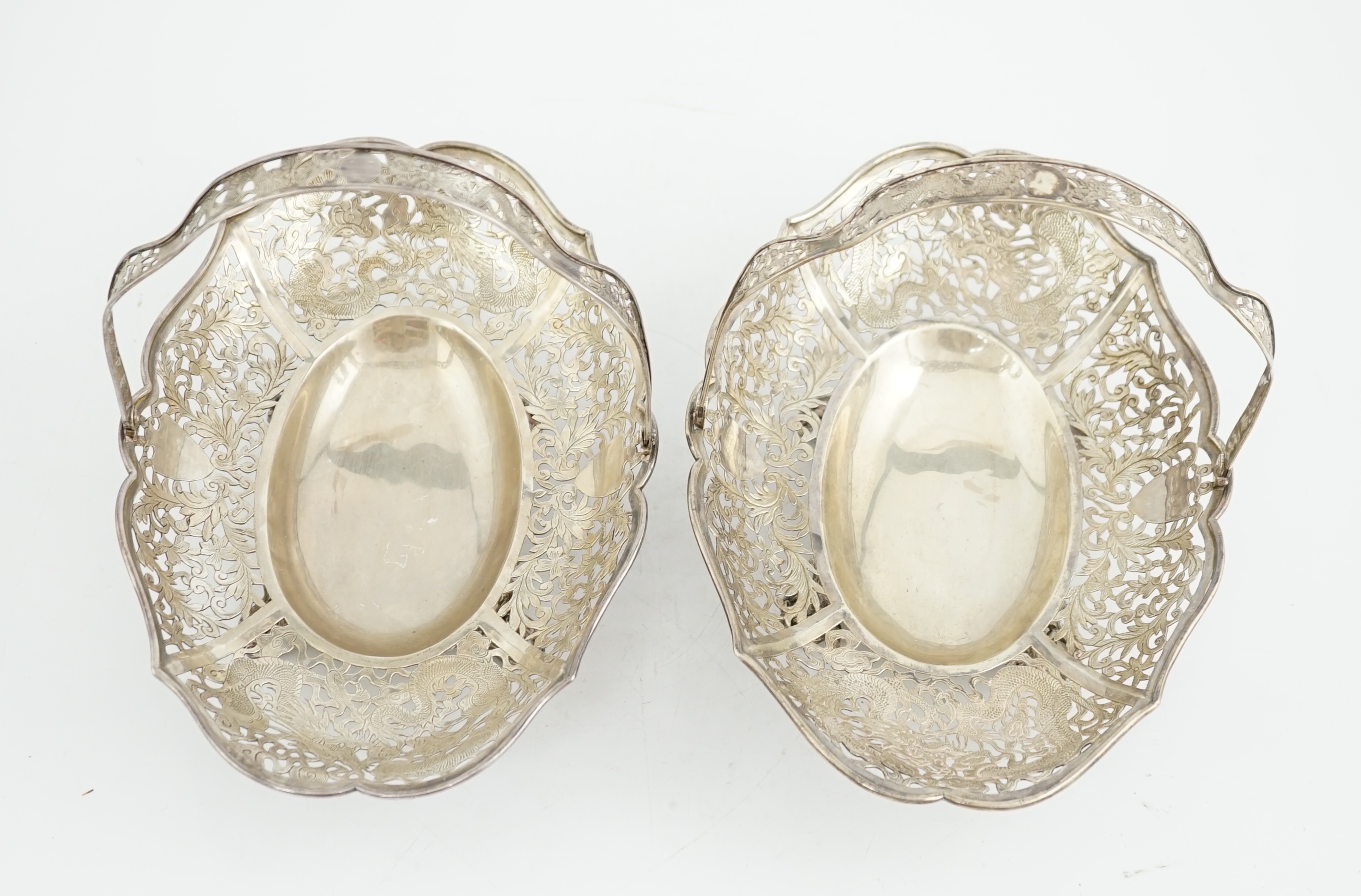 A pair of early 20th century Chinese Export pierced silver cake baskets, by Wang Hing, Hong Kong